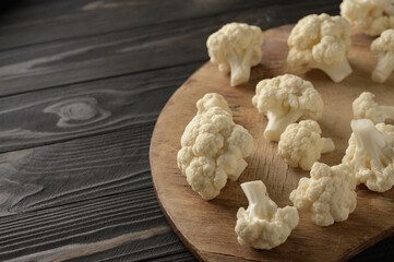 Raw, fresh organic cauliflower on a wooden background. Healthy eating, low carb diet concept
