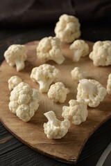 Raw, fresh organic cauliflower on a wooden background. Healthy eating, low carb diet concept