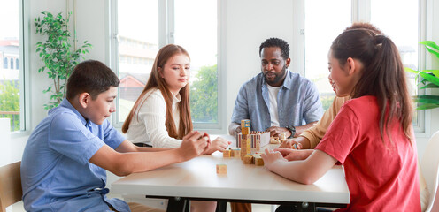 Caucasian and African students and African teachers. Smiling, doing activities, playing with wooden blocks