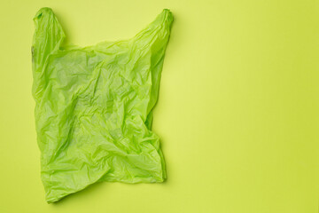 Disposable plastic bag on color background, top view