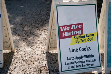 Sign at local restaurant during the time of Covid-19 looking to hire staff with a large hiring...