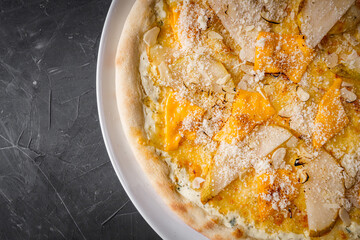 hot delicious traditional italian pizza on a dark stone background