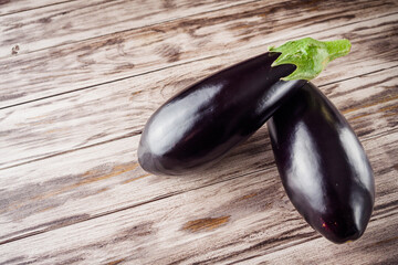 fresh natural eggplant on a light white wooden rustic background