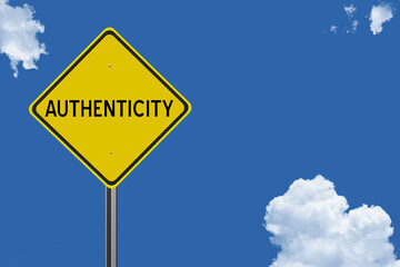 The word Authenticity on a yellow road sign on a blue sky background.  Inspirational concept for success in life.