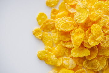 crispy golden cornflakes on a white acrylic background