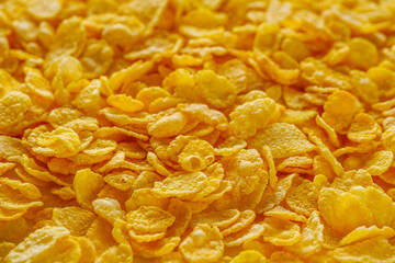 crispy golden cornflakes on a white acrylic background