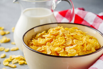 crispy golden cornflakes on a gray concrete background