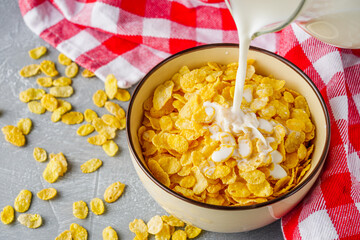 crispy golden cornflakes on a gray concrete background