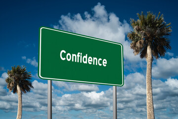 Fototapeta premium Highway sign with the word Confidence on a beautiful blue sky background with palm trees. Motivational concept for finding what we want on the journey of life.