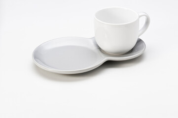 White ceramic cup with a double saucer, isolated on white