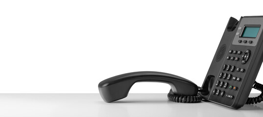Close up telephone devices at office desk for customer service support with B2B service technology...