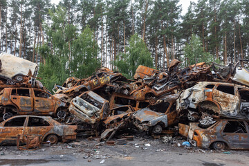 War in Ukraine. Car graveyard in Irpin. Shot cars of civilians.