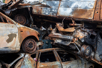 Fototapeta premium War in Ukraine. Car graveyard in Irpin. Shot cars of civilians.