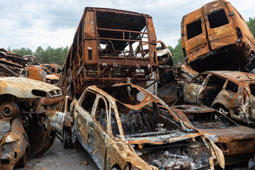 Fototapeta na wymiar War in Ukraine. Car graveyard in Irpin. Shot cars of civilians.