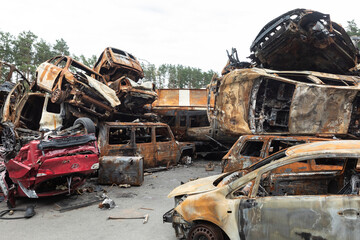 Fototapeta premium War in Ukraine. Car graveyard in Irpin. Shot cars of civilians.