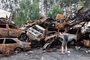 Fototapeta premium War in Ukraine. Car graveyard in Irpin. Shot cars of civilians.