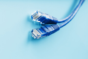 Blue Ethernet Cable Cord Patch cord on a blue background with free space