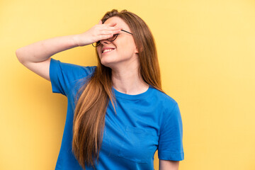 Young caucasian woman isolated on yellow background covers eyes with hands, smiles broadly waiting for a surprise.