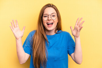 Young caucasian woman isolated on yellow background receiving a pleasant surprise, excited and...