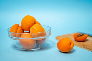 Healthy juicy apricots on blue background 