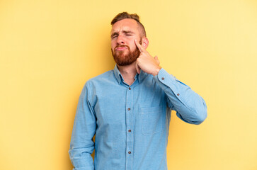 Young caucasian man isolated on yellow background crying, unhappy with something, agony and confusion concept.