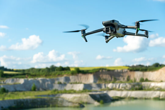 Grodno, Belarus June 11, 2022: A drone DJI MAVIC 3 explores an old abandoned quarry. Aerial photography of an industrial facility. An engineer uses a quadcopter to search for minerals.