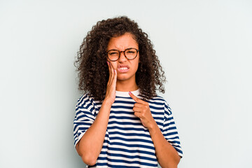 Young Brazilian woman isolated on blue background having a strong teeth pain, molar ache.