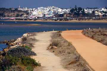 Alvor in estuary of Alvor river, staging post for migrating birds, area designated as Natura 2000 - environmental protection area, in background Alvor town, Faro district, Algarve, Portugal, Europe