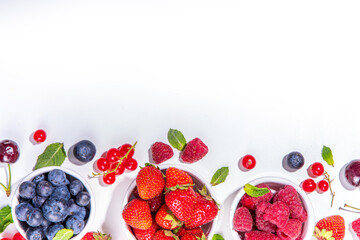 Summer vitamin food concept, set of various berries blueberry strawberry currant, flat lay on white background top view copy space