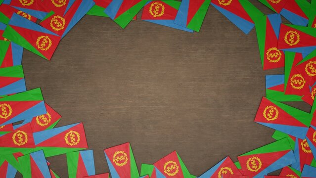 Frame made of paper flags of Eritrea arranged on wooden table. National celebration concept. 3D illustration