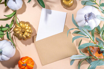 Fall seasonal flatlay. Autumn seasonal holidays background in pink colors. White, orange, golden pumkins decor for thanksgiving, fall holidays, invitation mock up background