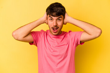 Fototapeta na wymiar Young caucasian man isolated on yellow background screaming, very excited, passionate, satisfied with something.