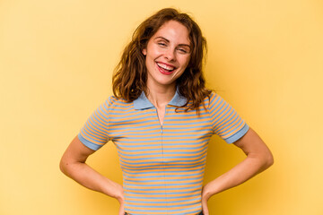 Fototapeta premium Young caucasian woman isolated on yellow background happy, smiling and cheerful.
