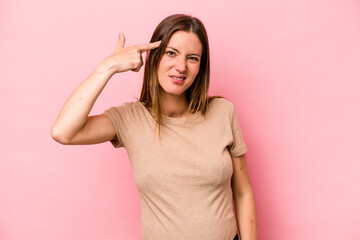 Young caucasian pregnant woman isolated on white background showing a disappointment gesture with forefinger.