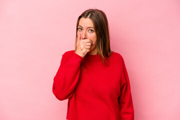 Young caucasian pregnant woman isolated on white background covering mouth with hands looking worried.