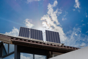 Photovoltaic panels or solar panels on the roof building against blue sky background