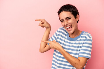 Fototapeta premium Young caucasian woman isolated on blue background excited pointing with forefingers away.