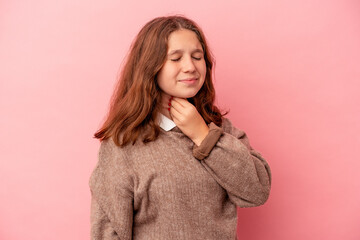 Little caucasian girl isolated on pink background suffers pain in throat due a virus or infection.