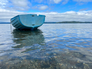 blue boat on the blue ocean water