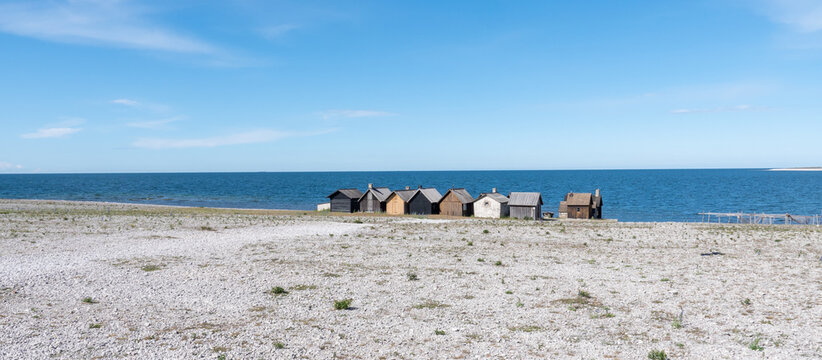 Fishermans cabin in a row by the sea. Huts on the island of Gotland in Sweden.