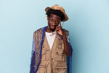 Young african american fisherman holding a net isolated on blue background pointing temple with finger, thinking, focused on a task.