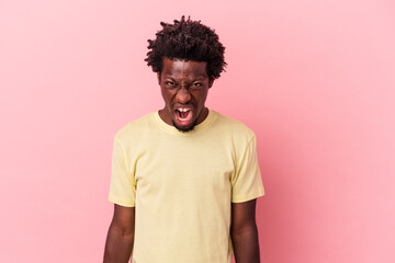 Obraz na płótnie Canvas Young african american man isolated on pink background shouting very angry, rage concept, frustrated.