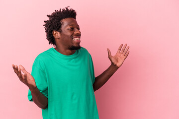 Young african american man isolated on pink background joyful laughing a lot. Happiness concept.