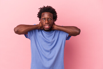 Young african american man isolated on pink background touching back of head, thinking and making a choice.