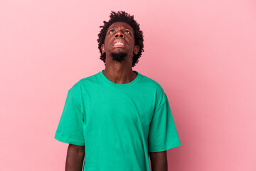 Young african american man isolated on pink background shouting very angry, rage concept, frustrated.