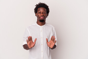 Young african american man isolated on white background  rejecting someone showing a gesture of...