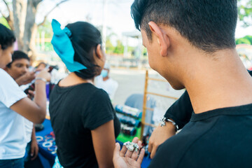 Latin teenager buying bracelets in a street business in a tourist site in Managua, Nicaragua