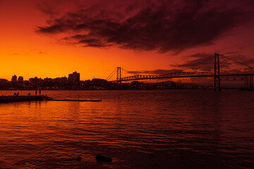 Hercilio luz cable bridge with sunset sky and reflection on water in Florianopolis