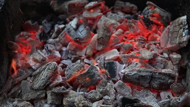 Burning red organic charcoal texture in bbq grill. High quality FullHD footage