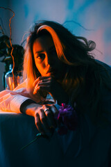 Portrait of attractive caucasian woman sitting at table with candles in the evening.